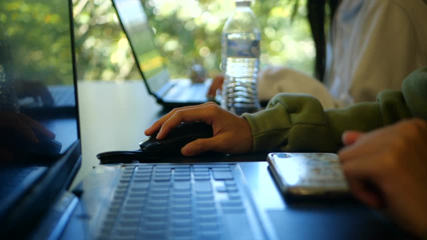 Twins working and studing for a test