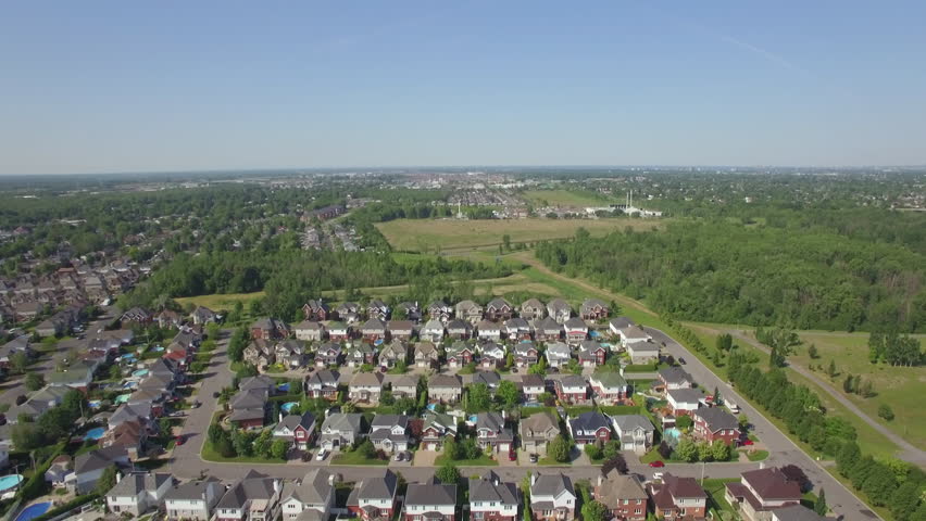 Aerial tilt down shot showing rows of houses in beautiful residential neighbourhood in Montreal, Quebec, Canada. 