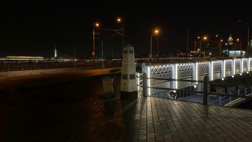 A beautiful view of traffic road and train from a harbor during the night