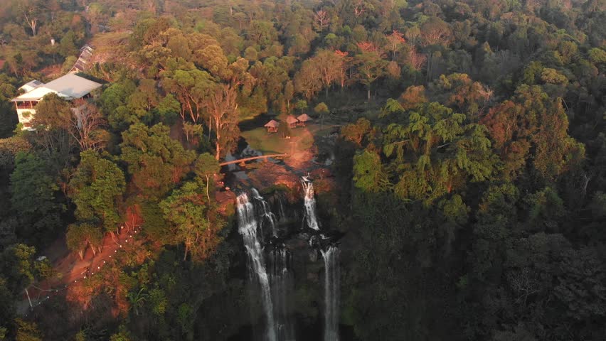 Drone view of the famous Tad Gneuang Waterfall at Laos during sunset, aerial Royalty-Free Stock Footage #1109712281