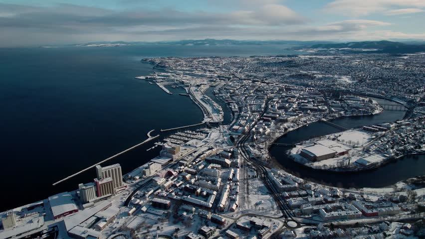 Drone Aerial View of Trondheim, Norway. City Harbor, Snow Capped Buildings on Sunny Winter Day