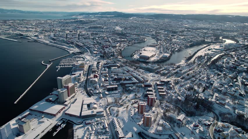 Aerial View of Trondheim, Norway. Cityscape on Sunny Winter Day, Snow Capped Buildings, Fjord and River