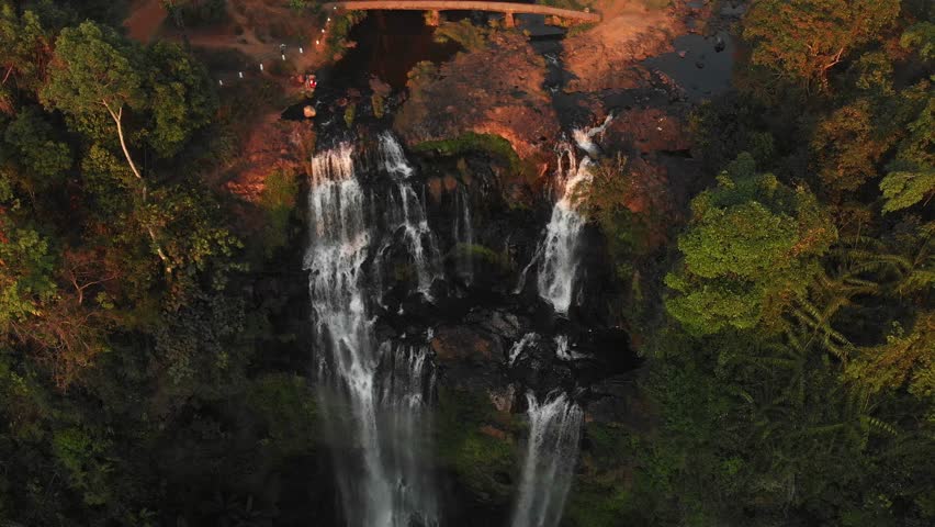The Tad Gneuang Waterfall at Loas during sunset, aerial Royalty-Free Stock Footage #1109712923