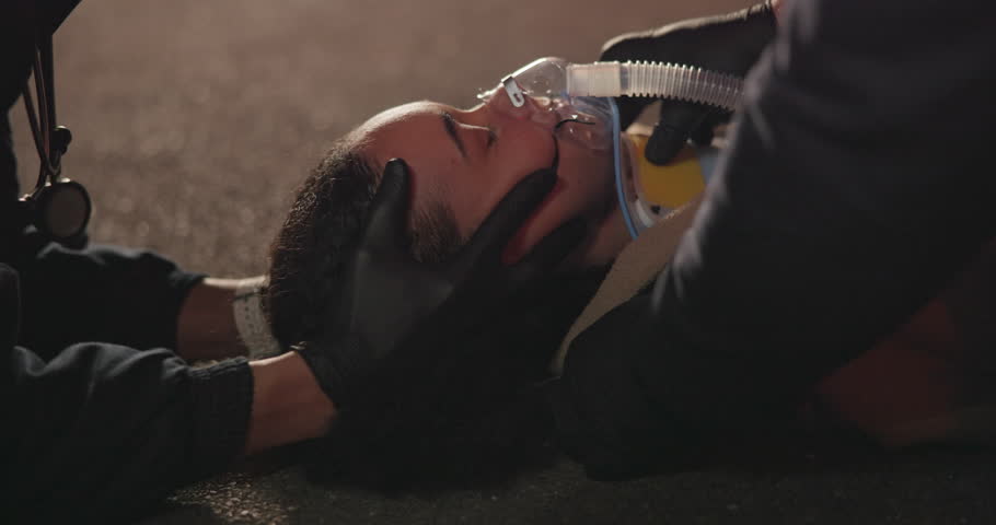 Accident, patient and neck brace by face with hands, night and paramedic for medical service. Victim, closeup and saving or rescue from disaster, first aid and cpr and oxygen mask for drunk driving Royalty-Free Stock Footage #1109713541