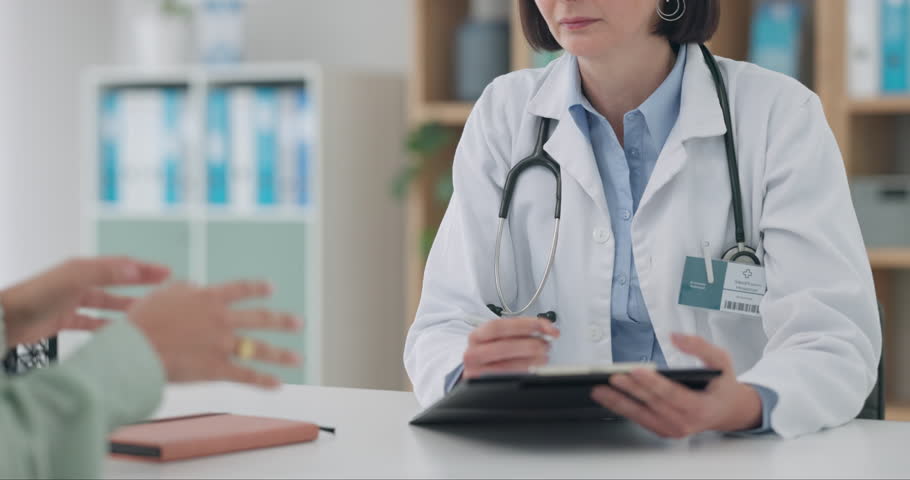 Heathcare, writing and woman consulting doctor in consultation room for insurance, checklist or paperwork. Hospital, clipboard and female patient with gp in a clinic for advice, history or plan