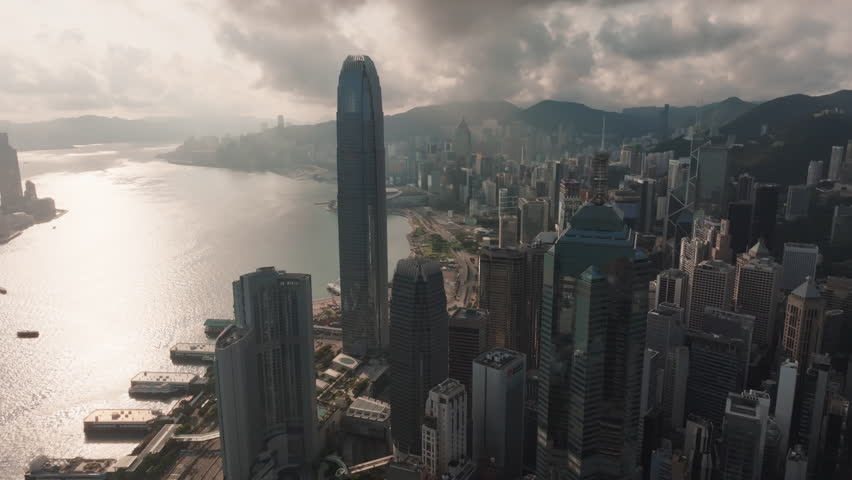 Drone view of Hong Kong cityscape at night at Victoria Harbour, drone aerial top view. Asia travel destination ,business finance and economy concept