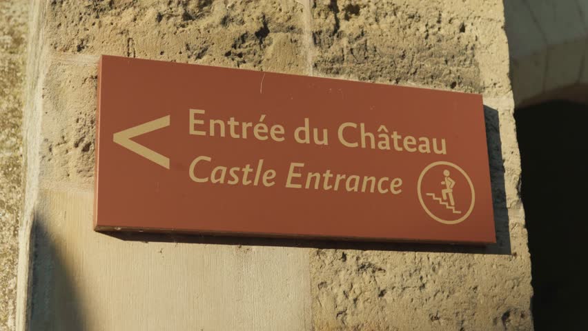Signage indicating direction to castle entrance. Instructions for visitors