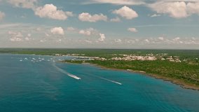 Drone flying over blue sea of Bayahibe coast, Dominican landscape, La Romana. Aerial forward