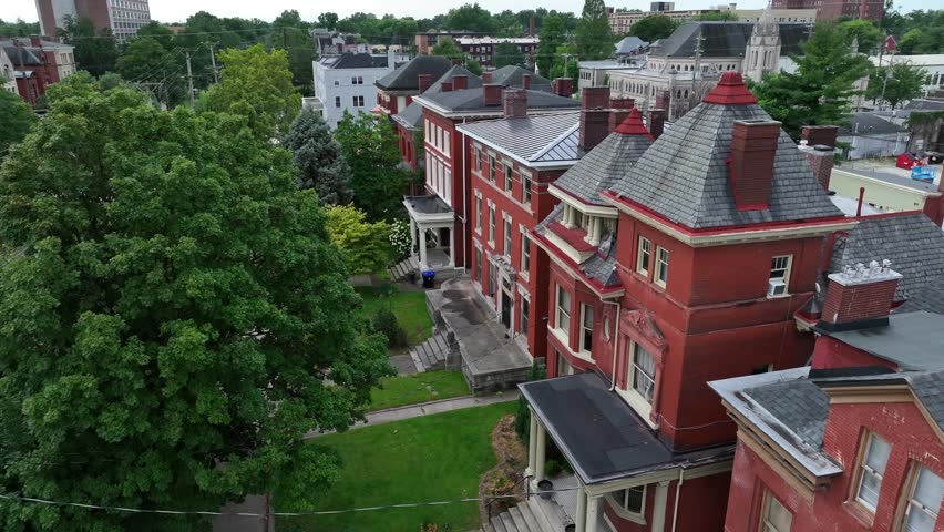 Victorian homes in the historic district of American city. Aerial establishing shot of old, brick houses.