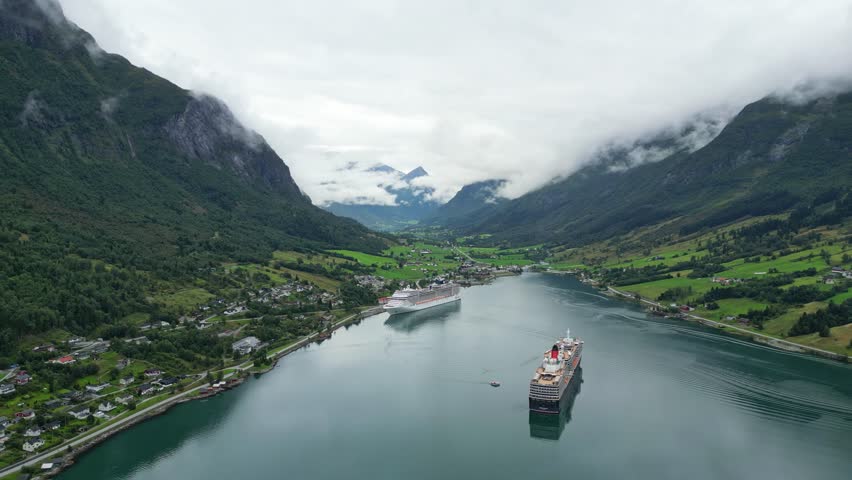 Cruise Ships anchored at Olden Village in Nordfjord, Vestland, Norway, Scandinavia - Aerial Circling