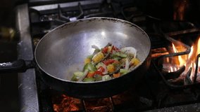 The chef pours olive oil into the wok. Grilling vegetables in the wok pan over burning gas stove. - Powered by Shutterstock - Get 15% off with code: PIKWIZARD15