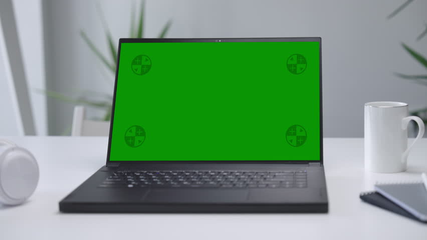  Modern Laptop Computer on White Desk with Blank Empty Green Mockup Screen Royalty-Free Stock Footage #1109725897