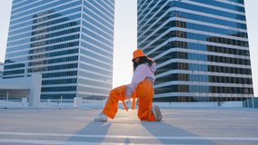 Funny girl performing cool dance at glass office buildings background. Concept of hip hop and break dance performance for music video. Youth subculture contemporary choreography RED camera slow motion - Powered by Shutterstock - Get 15% off with code: PIKWIZARD15