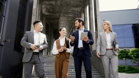 Business team of businessmen employees colleagues are walking near the office building on the stairs. A group people of businessperson in formal suits are talking and communicating together outdoors - Powered by Shutterstock - Get 15% off with code: PIKWIZARD15