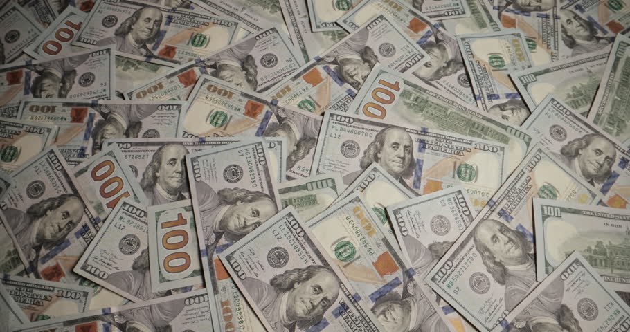 Bunch of dollar banknotes blows off table. Paper money blown away table by wind. Concept of wasting money, departing wealth, declining profits, wages, falling business, destroying commercial scheme.