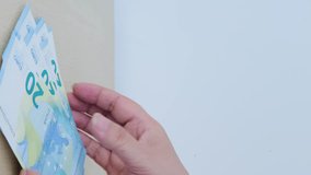 vertical video, female hands count paper 10, 20 euro banknotes, puts on table, concept of human poverty, inflation, payments to fund, gift for holiday, Financial planning, social assistance poor - Powered by Shutterstock - Get 15% off with code: PIKWIZARD15