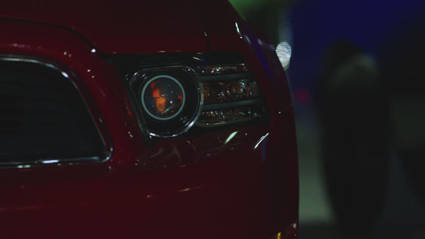 Close up front headlights of muscle car turning on . American sport car is ready to start the race . Engine starting to work . Blue vintage automobile on dark background . Headlamp blinking at night Royalty-Free Stock Footage #1109743613