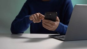 Woman sitting at table using mobile phone, online working on laptop, searching the information on internet network.  - Powered by Shutterstock - Get 15% off with code: PIKWIZARD15