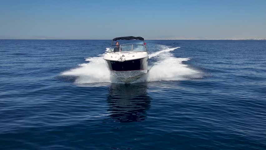 Front view of a sports motor boat cruising with high speed over the blue ocean Royalty-Free Stock Footage #1109747989