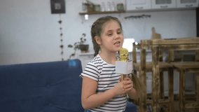 Home entertainment concept for children. the girl cheerfully sings karaoke songs and dances by the sofa. home party with karaoke.happy girl holding microphone and singing.celebration for child at home - Powered by Shutterstock - Get 15% off with code: PIKWIZARD15