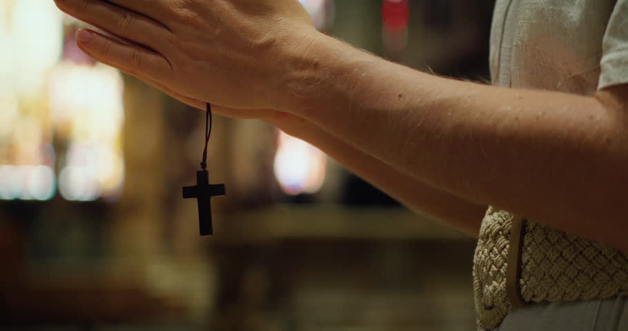 Christian believer with wooden cross in hands when praying. Religious paraphernalia, concept of religion, fasting.