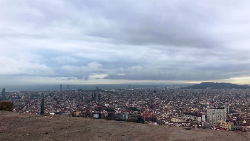 Panoramic Time lapse of Barcelona cityscape captured from The Bunker hill. Cloudy weather adds drama. Royalty-Free Stock Footage #1109761017