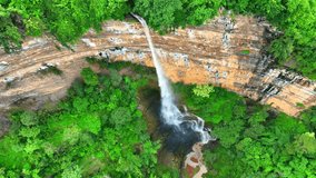 Nam Nao Canyon's aerial view showcases nature's artistry with cascading waterfalls nestled amidst lush greenery, a picturesque masterpiece. (Nam Nao National Park, Thailand). Drone video footage.
