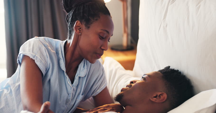Bed, love and African couple talking in bedroom together with care in relationship and with happiness in the morning. Calm, bonding and happy man with woman for romance to relax in home on vacation Royalty-Free Stock Footage #1109771071