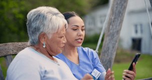 Nurse, phone and talking to senior woman outdoor with social media, news or communication in backyard. Online, discussion and person with elderly care in retirement, garden or caregiver show a video