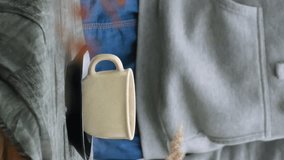 Keep warm, autumn tea party. Vertical video. Young woman drinking tea in back yard garden. - Powered by Shutterstock - Get 15% off with code: PIKWIZARD15