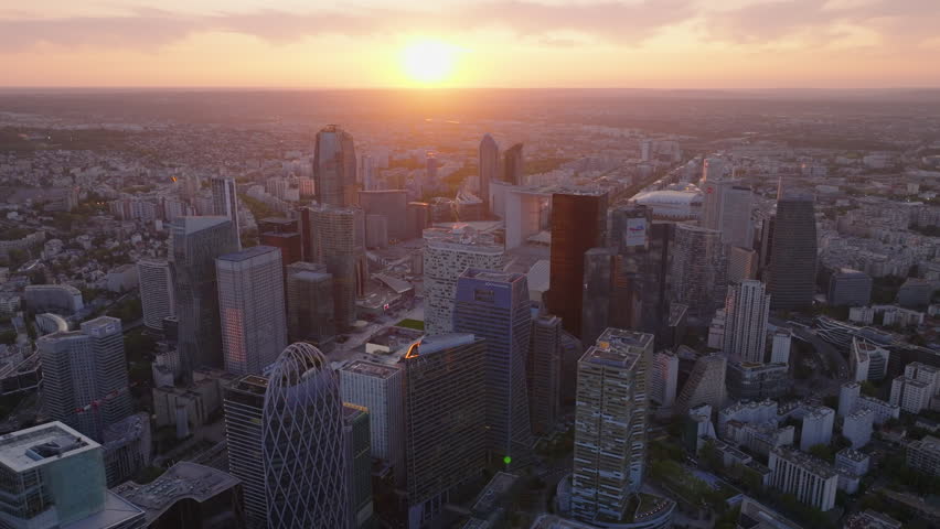Aerial slide and pan footage of modern high rise office buildings in La Defense business district against sunset sky. Paris, France Royalty-Free Stock Footage #1109775697