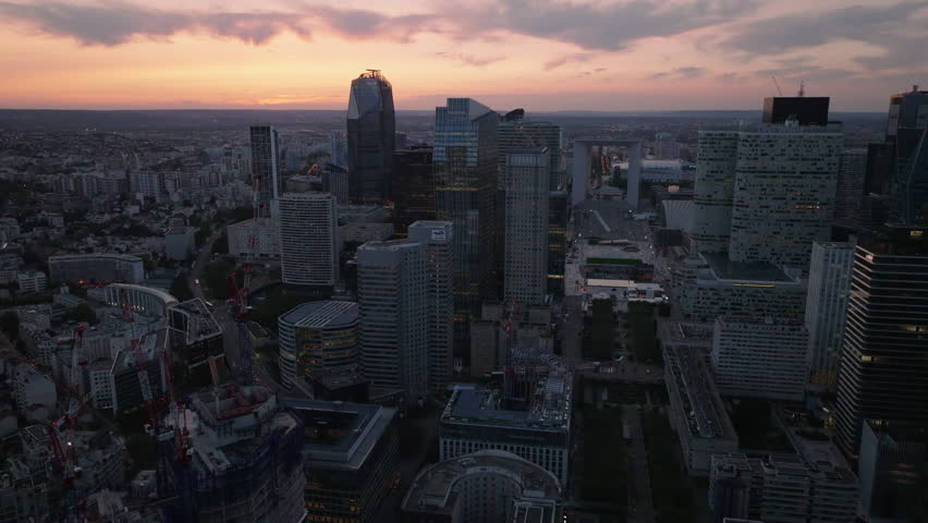 Aerial footage of group of modern office skyscrapers in futuristic business district. La Defense against sunset sky. Paris, France Royalty-Free Stock Footage #1109775749