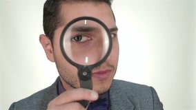 Young businessman looking through magnifying glass - Powered by Shutterstock - Get 15% off with code: PIKWIZARD15
