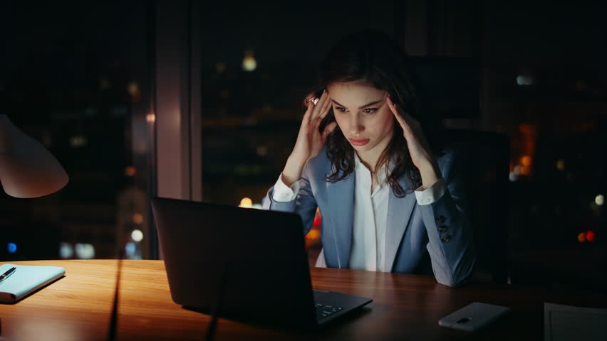 Woman entrepreneur feeling headache working at laptop late evening close up. Tired overworked businesswoman looking computer monitor sitting dark workplace. Fatigued girl manager overworking at night. Royalty-Free Stock Footage #1109780255