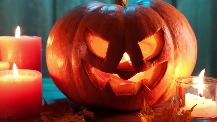halloween pumpkin head jack lantern on wooden background. dramatic lighting.