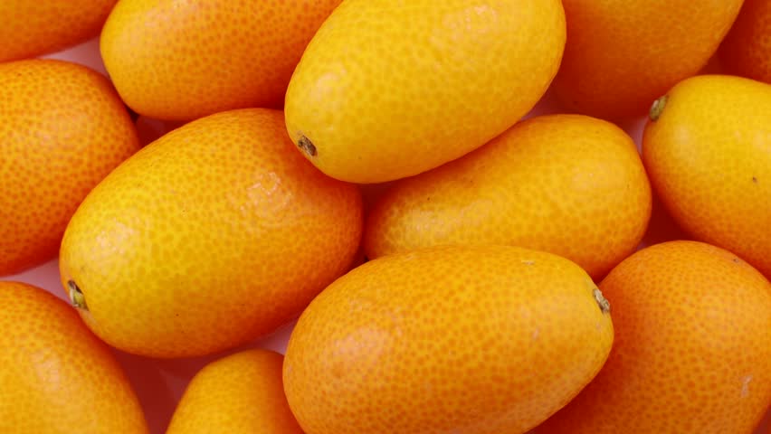 Top view of bright orange kumquat fruit circle rotation close up Royalty-Free Stock Footage #1109786679