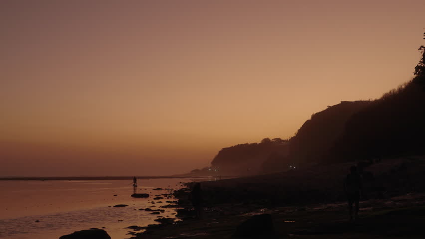 Man rowing boat canoe sunset Bali Gunung Payung Beach Indonesia