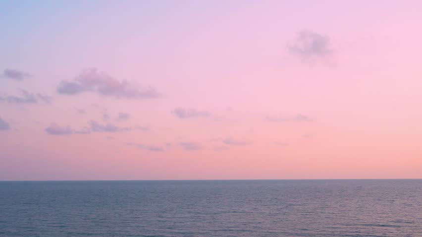 Time Lapse Sunset Ocean Colorful Sky and Few Fluffy Colored Clouds Horizon Background 4K. Beautiful Aerial View of Evening Sea and Sky Planet World Travel Vacation Relax Beauty Background 4K Seascape.