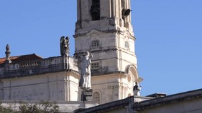 Fatima Church basilica. 4K video with the church from Fatima, Portugal, against blue clean sky, while the bells are ringing. Religious landmark monastery from Portugal.