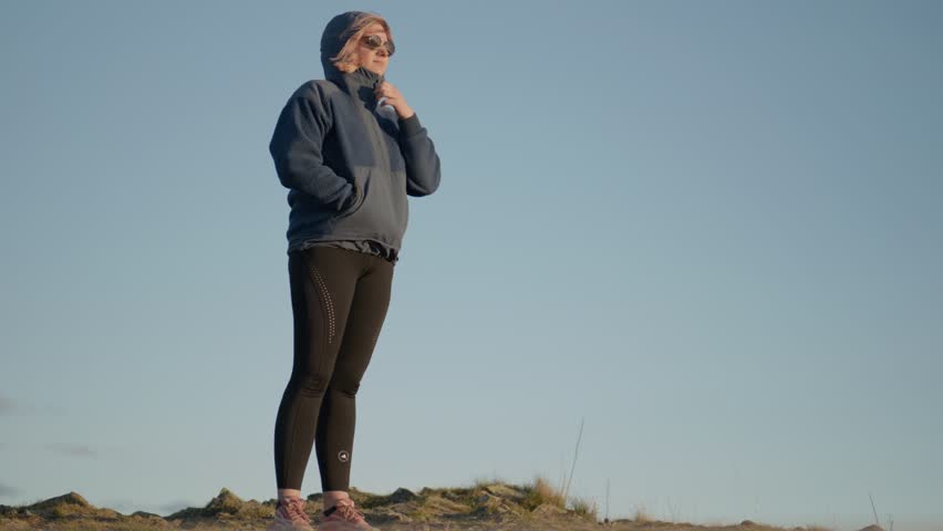 Slow motion shot of a female hiker enjoying the views at the Benmore Peninsula hike summit