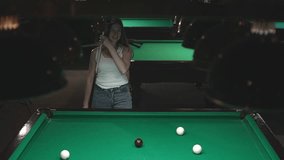 woman plays billiards. a woman hits a billiard ball into a hole. Russian billiards. slow motion video. Record high quality video in Full HD format. 