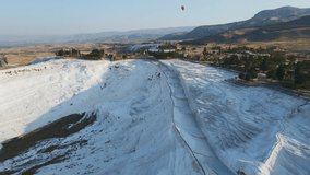 Aerial view of the travertines in Pamukkale, Turkey. White limestone mineral formations