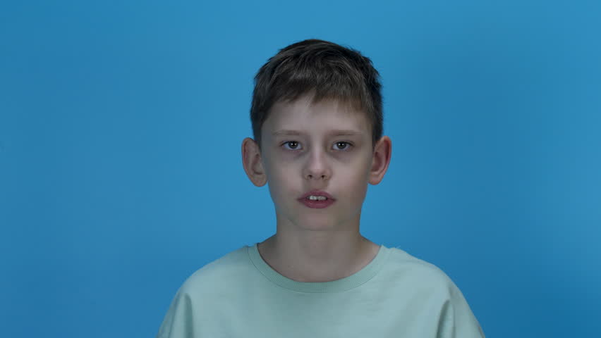 Angry irritated boy. Full of rage. Emotional portrait of an upset preteen boy screaming in anger. Requirements for parents. Wrong perception. Hysterics. Royalty-Free Stock Footage #1109805917