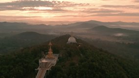 Epic view gold big Buddha statue in Thailand temple in the rays of the rising sun on background foggy mountain landscape Asian culture and religion 4K