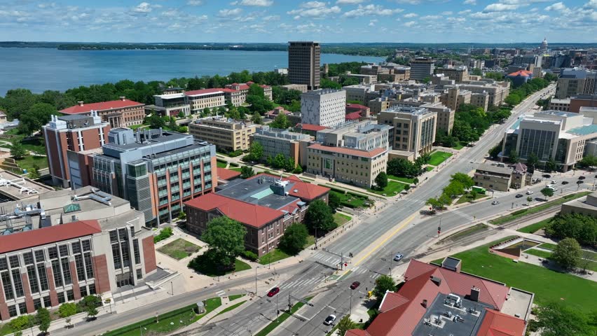 University of Wisconsin main campus in Madison, WI. Aerial shot of academic buildings and dorms on beautiful summer day with Lake Mendota in background.