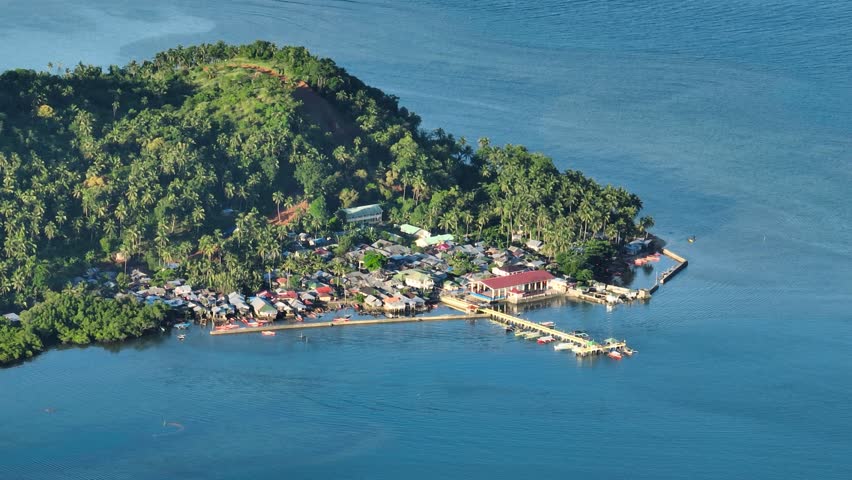 Stilt houses and blue sea in tropical island. Mindanao, Philippines. Zoom view.