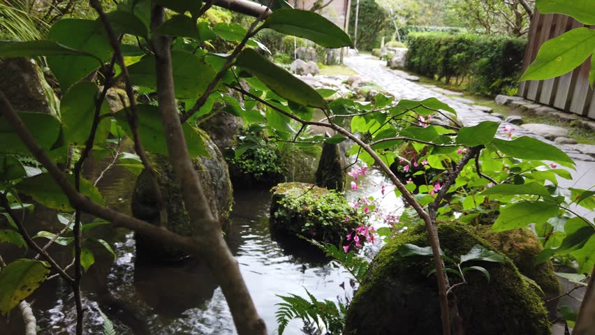Japanese Garden Fountain with Flowers inside a Buddhist Temple in Kyoto Japan