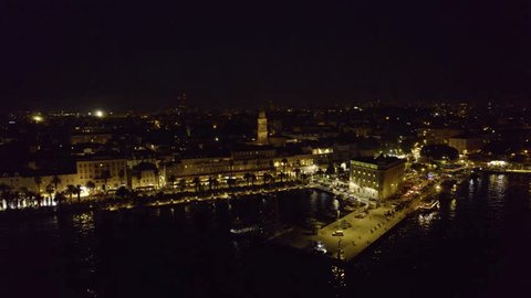 Aerial night view of Split, Croatia: city lights and sprawling urban tapestry Stockvideó