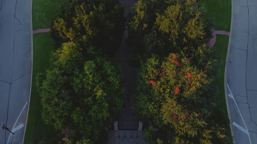 Austin, Texas State Capital Building, Aerial Drone Shot Flying over Courtyard and Goddess of Liberty Statue on Top with Views of The University of Texas at Austin Campus at Sunset in 4K.