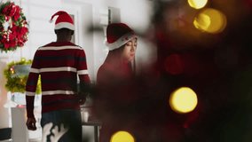 Sad staff member in festive decorated office packs desk belongings on last day at work, consoled by coworkers. Asian woman wearing xmas hat getting fired from job during Christmas, clears workstation - Powered by Shutterstock - Get 15% off with code: PIKWIZARD15